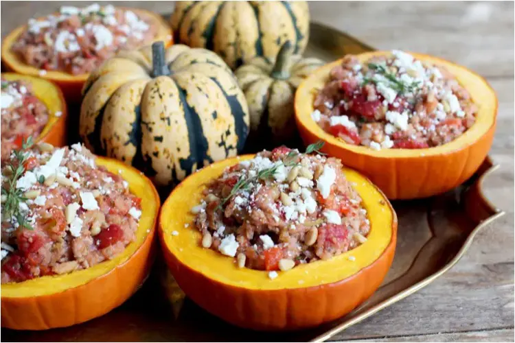 A halved roasted pumpkin stuffed with spiced turkey mince and rice.