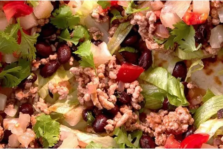 A crispy tostada topped with smoky pork mince and pineapple, a must-try pork mince recipe.