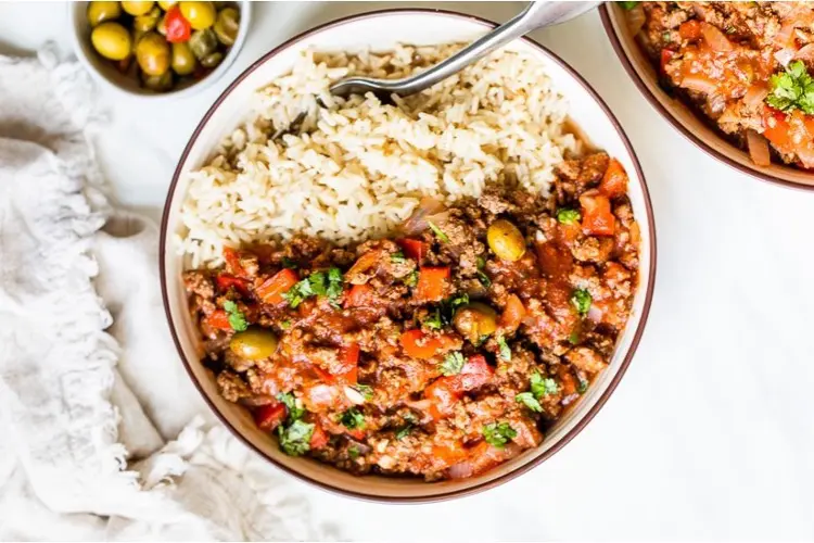A slow-cooked pot of rich minced beef picadillo, packed with olives, tomatoes, and spices.