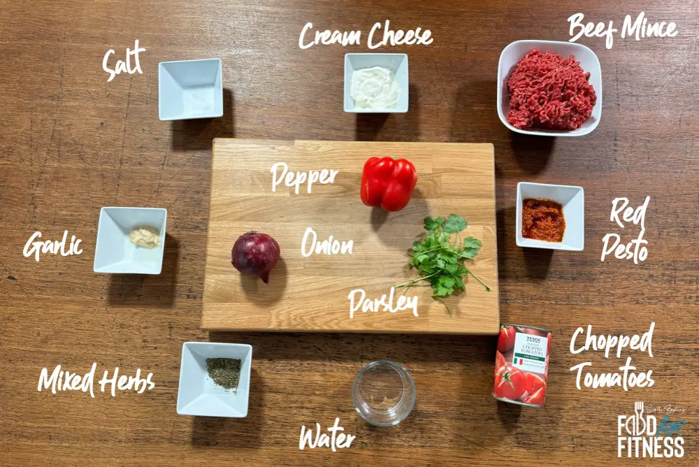 A colourful array of fresh ingredients ready to create magic – juicy beef mince, vibrant peppers, rich red pesto, and creamy cheese, all waiting to be transformed into a comforting bowl of creamy beef pasta.