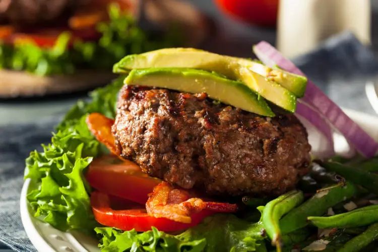 A juicy minced beef burger topped with avocado, a spicy beef mince recipe with a kick.