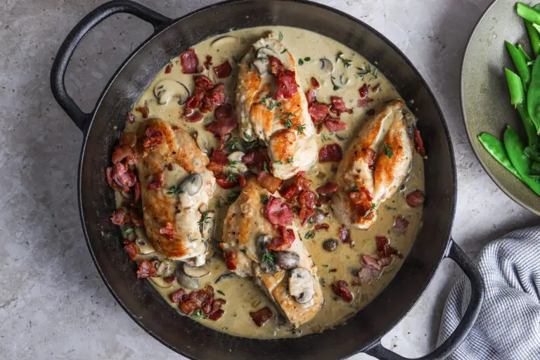 Golden chicken supreme topped with crispy bacon, served with creamy mushroom sauce.