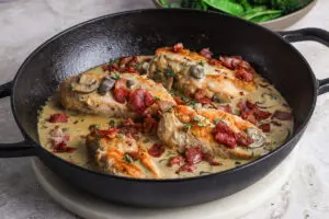 Close-up of Chicken Supreme with Bacon, showcasing golden chicken and creamy sauce.