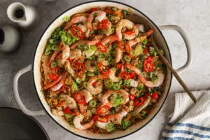 Spicy Singapore Fried Rice with prawns, chicken, and veg topped with sliced chillies and spring onions.