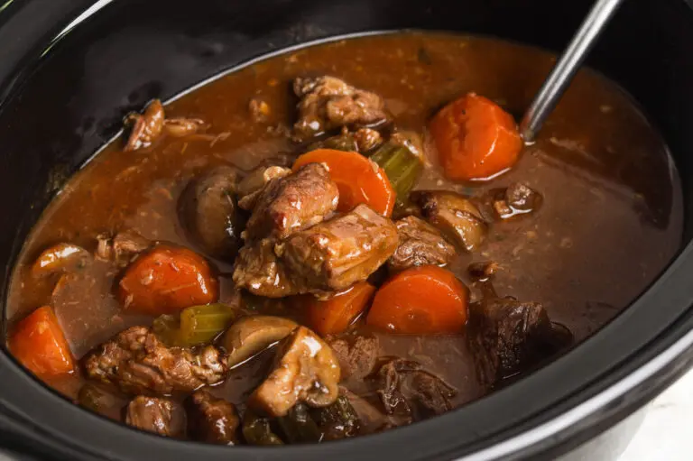 Close-up of Slow Cooker Beef Casserole with tender beef, carrots and celery in rich gravy.