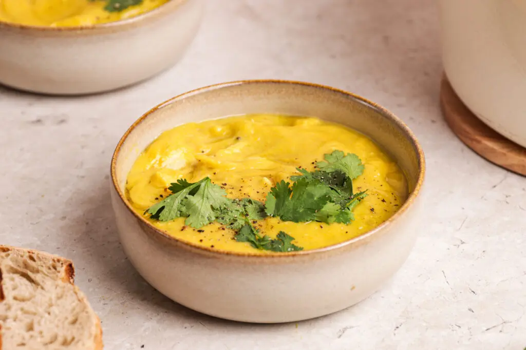 Creamy curried parsnip soup topped with fresh coriander and cracked black pepper