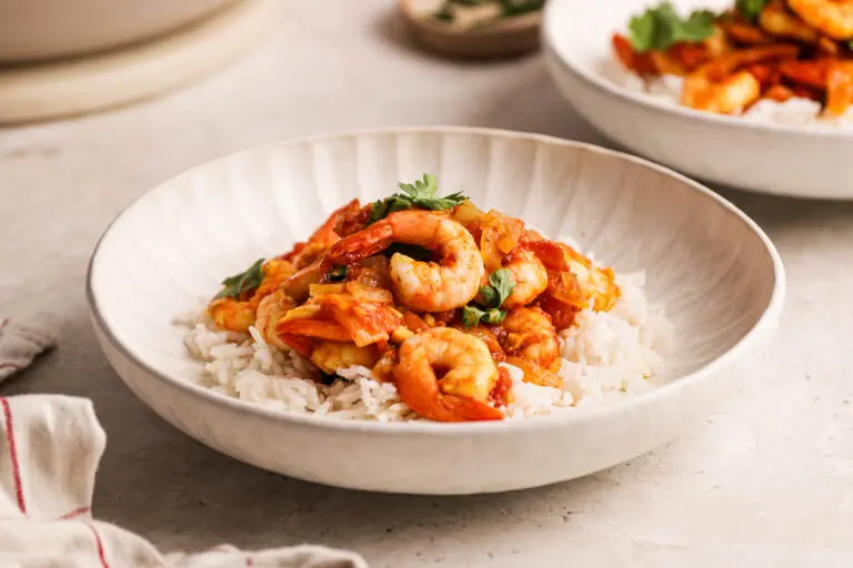 High-protein prawn curry served over fluffy white rice in a shallow bowl.