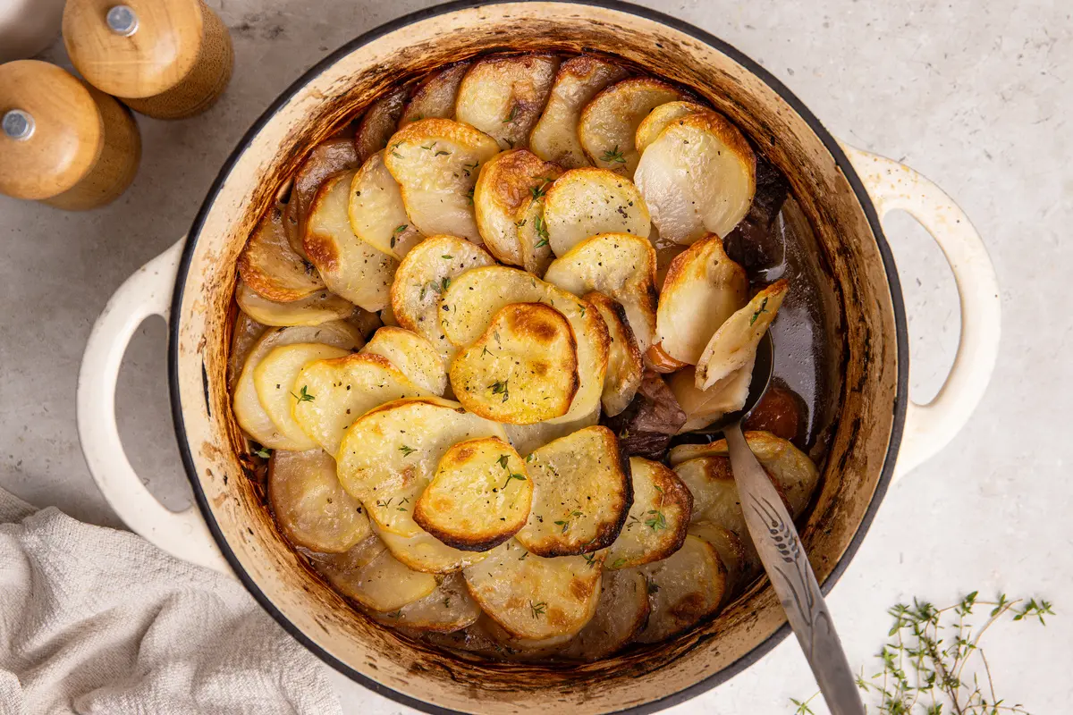 High-protein beef hot pot with golden sliced potato topping in casserole dish