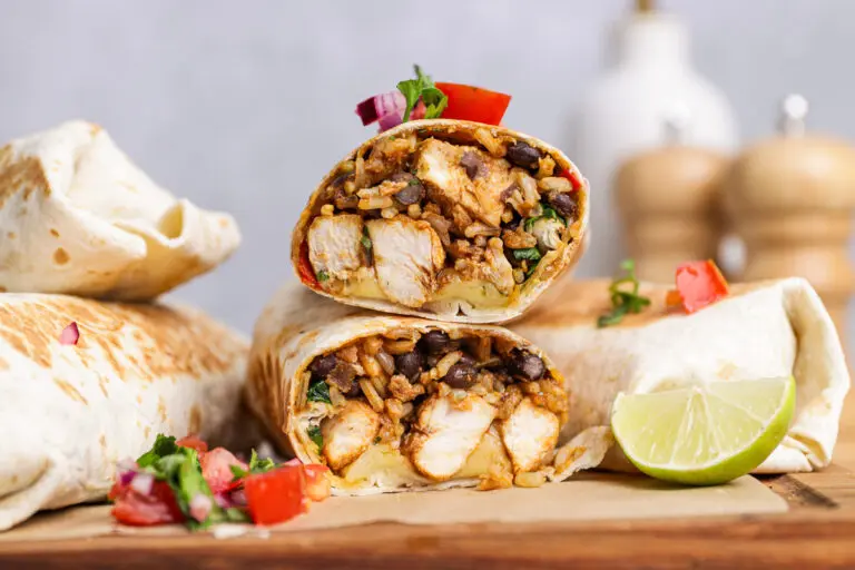 Close-up high-protein chicken burrito cut open showing rice and black beans