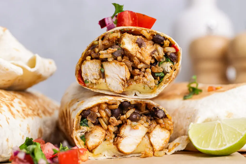 Stacked chicken burritos with smoky chipotle filling and melted cheese