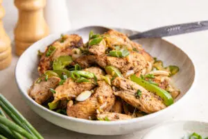 Close-up of high-protein salt and pepper chicken with garlic, chilli and spring onions