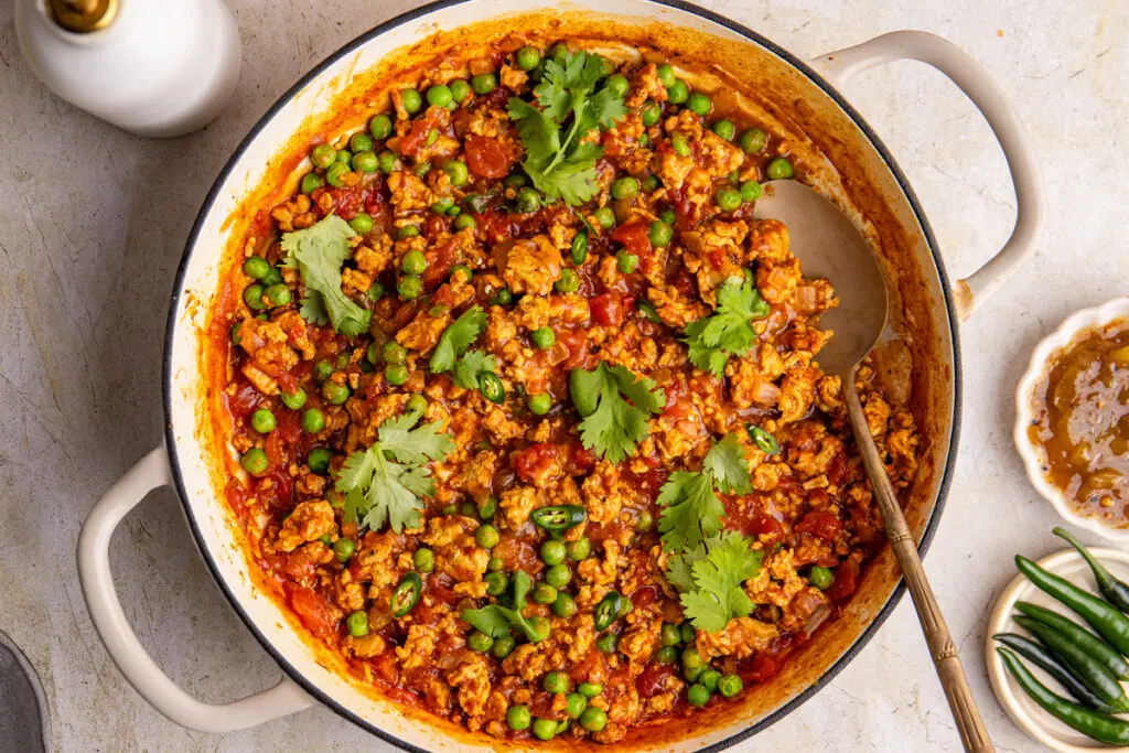 High-protein chicken keema in pan with peas, coriander and rich tomato curry sauce