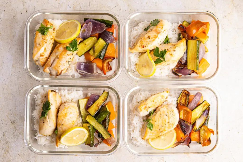 High-protein lemon chicken with rice and roasted vegetables in meal prep boxes