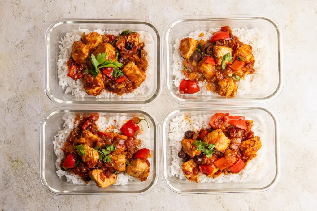 High-protein Brazilian chicken stew portioned into meal prep containers with rice