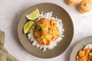 Cajun chicken ingredients with chicken breast, spices, pepper, tomatoes, cream, lime and herbs