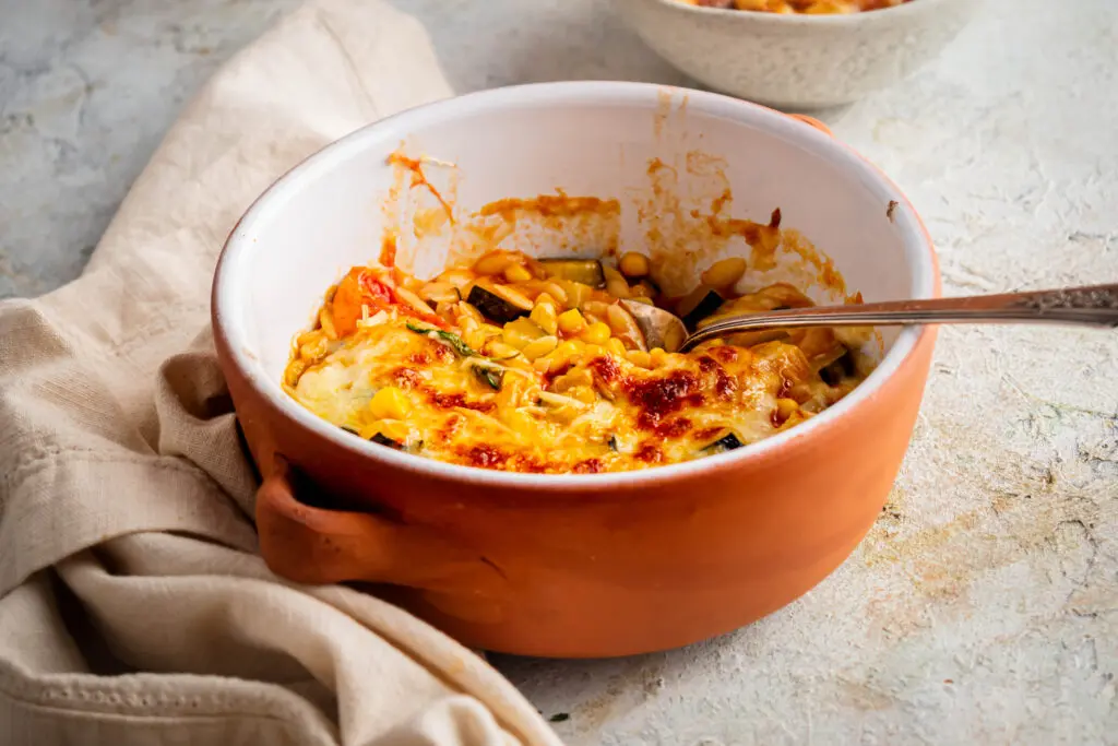 Creamy cheesy orzo with courgette, sweetcorn and tomatoes, baked until golden and bubbling.