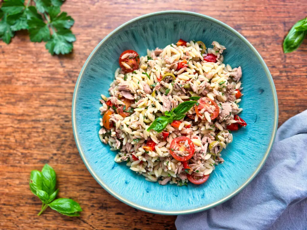 Greek-style tuna and orzo salad with tomatoes, peppers, olives and fresh basil.